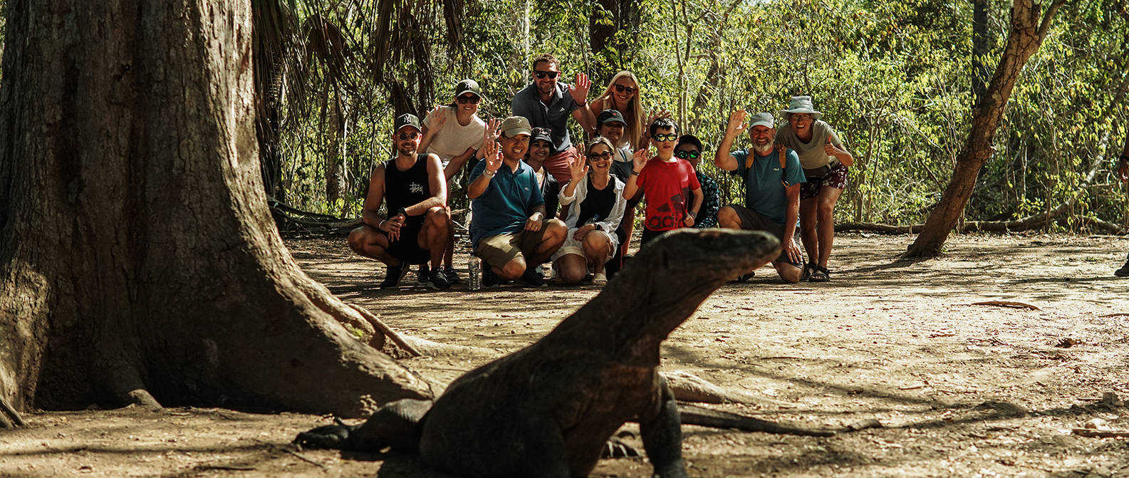 Tourist spotting a Komodo dragon on Rinca Island during a day trip